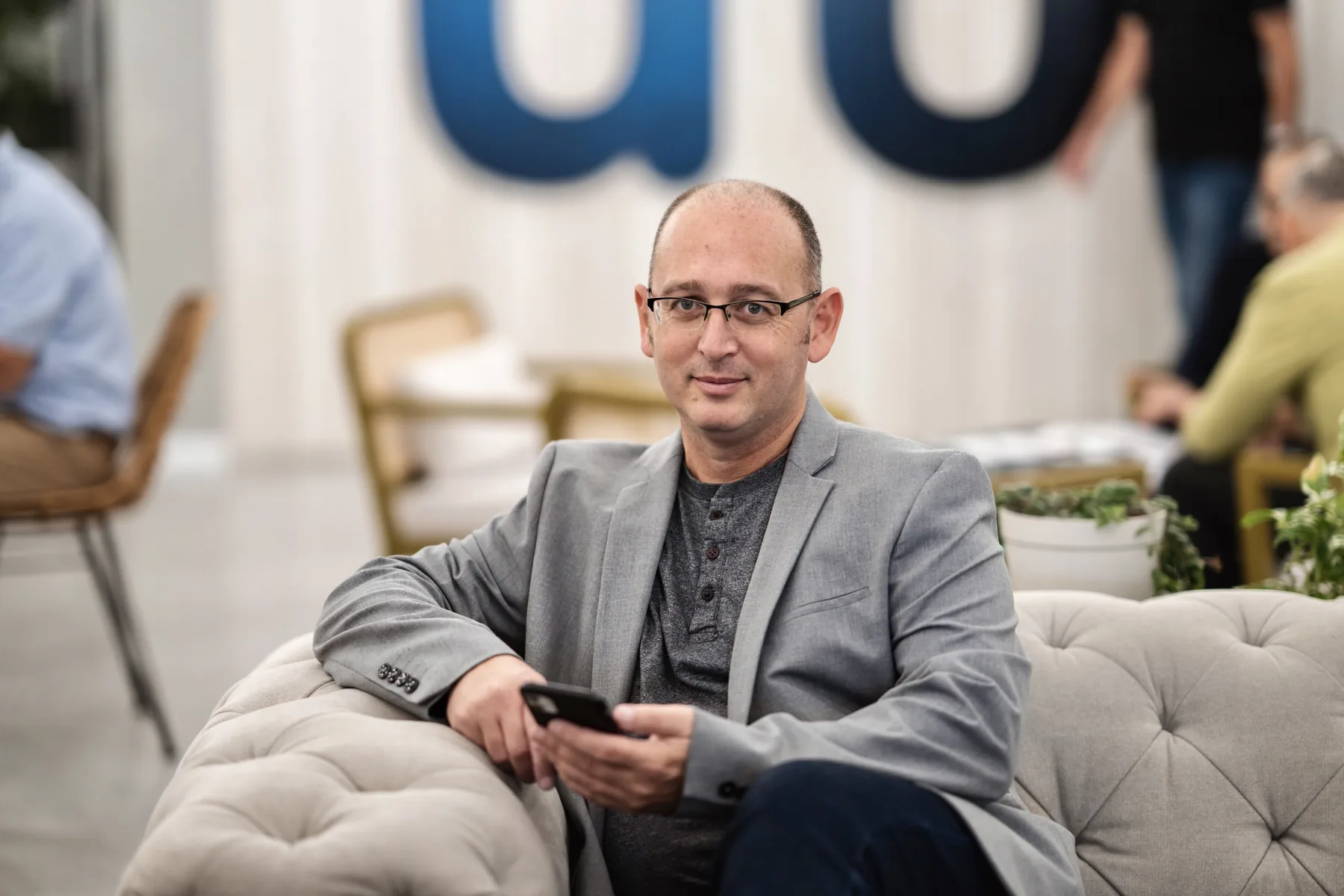 Ami Halfon seated at a professional event