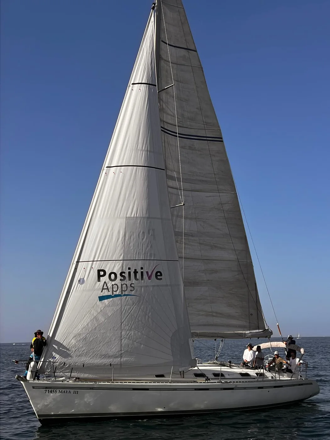 Sailing boat carrying the Positive-Apps logo